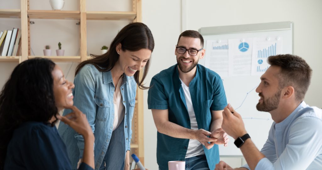 Smiling,Diverse,Colleagues,Gather,In,Boardroom,Brainstorm,Discuss,Financial,Statistics